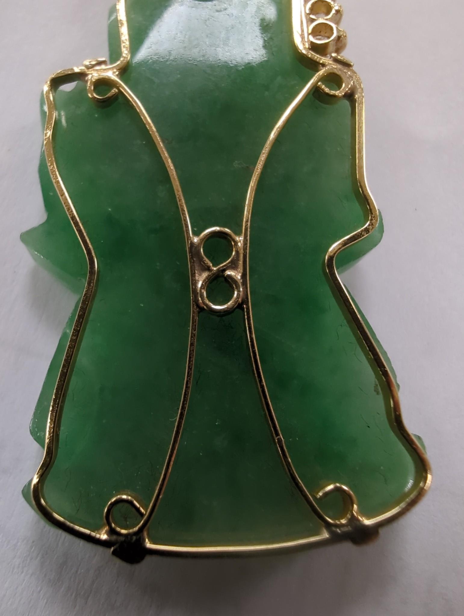 A modern 18k and diamond chip mounted jadeite pendant, carved as an immortal, 40mm, gross weight 9.1 grams.